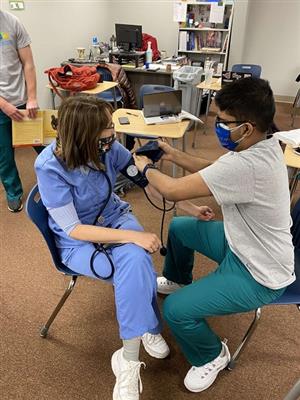 Students practice taking bloodpressure
